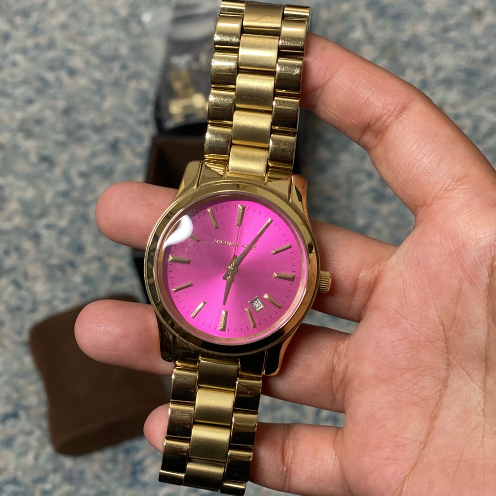 Micheal Kors pink face watch.